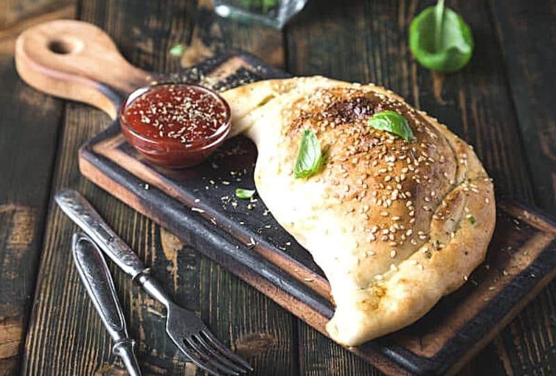 Selection of savory calzones from Ronzio's with pepperoni, ham, and veggie fillings for Kidz Kastle guests