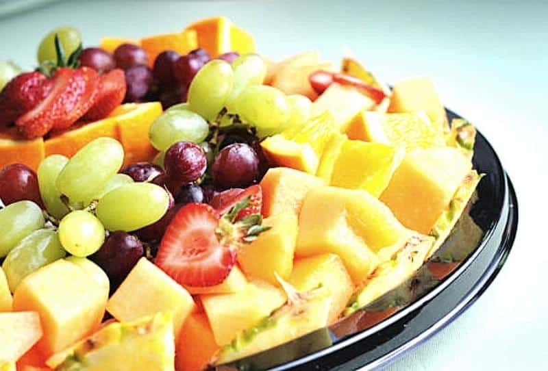 Fresh fruit platter with honeydew, pineapple, cantaloupe, and grapes for Kidz Kastle parties