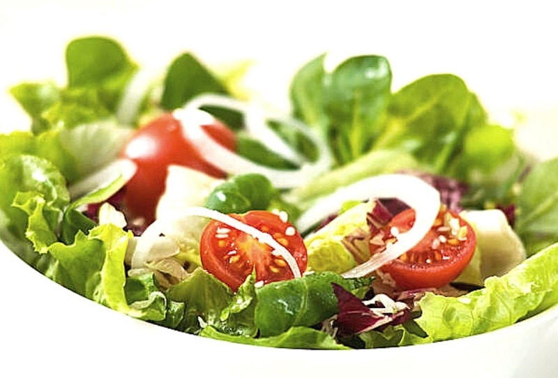 Crisp garden salad with iceberg lettuce, tomato, red onion, bell pepper, and olives for parties at Kidz Kastle