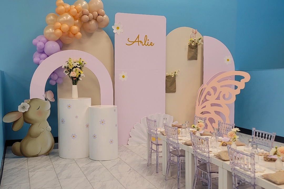 Boho bunny and daisy themed birthday party with custom name backdrop and floral decor at Kidz Kastle RI