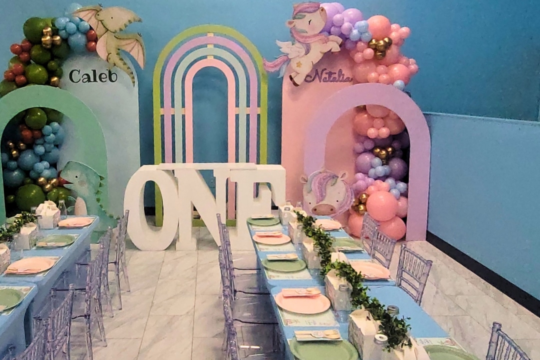 Magical unicorn and rainbow themed birthday party with shimmer wall and pastel balloon arch at Kidz Kastle RI