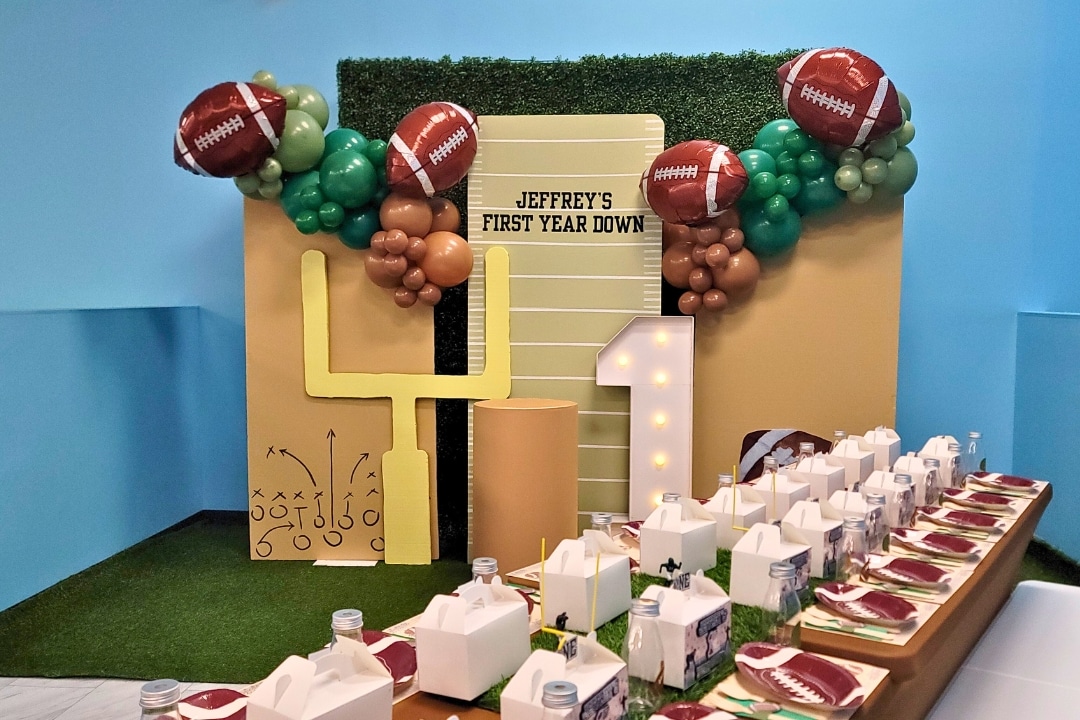 Football themed first birthday First Year Down with goal post and turf inspired table decor at Kidz Kastle RI