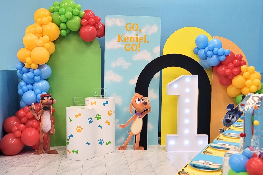 Go Dog Go themed first birthday party with primary color balloons and light up number one at Kidz Kastle RI