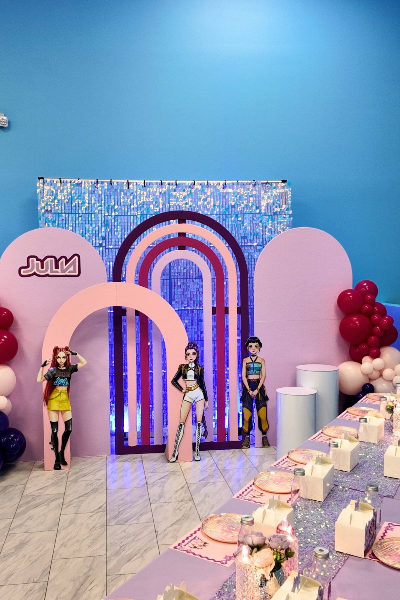 K-Pop and Demon Hunter themed birthday setup with shimmer wall and custom backdrop.