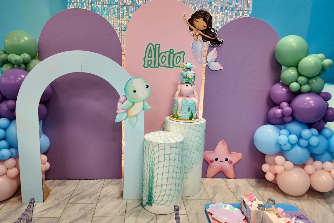 Under the sea mermaid themed birthday party with custom cake stand and purple and teal balloon styling at Kidz Kastle RI