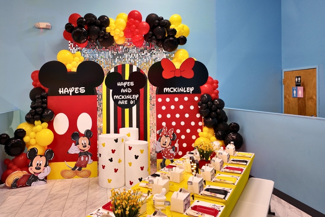 Joint Mickey and Minnie Mouse themed birthday party with red yellow and black balloon decor at Kidz Kastle RI