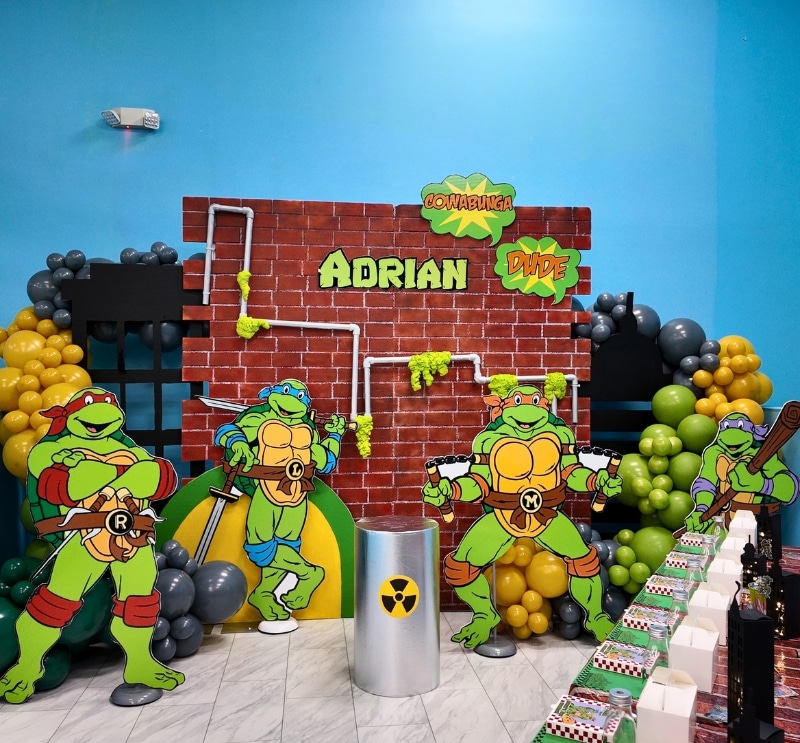 Ninja Turtle themed birthday setup with character backdrops and balloon decor.