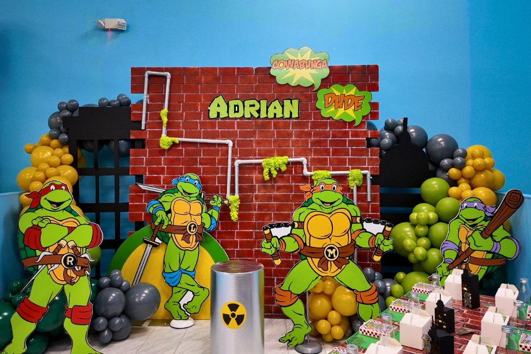 Teenage Mutant Ninja Turtles themed birthday party with brick wall backdrop and toxic ooze balloon styling at Kidz Kastle RI