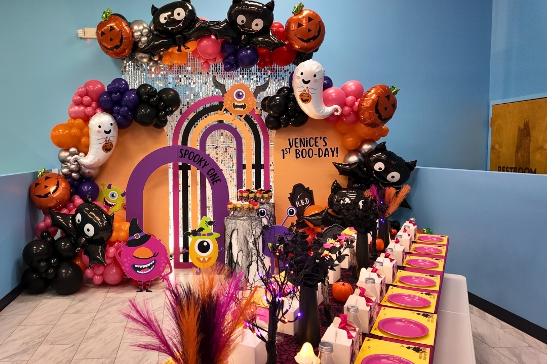 Spooky One themed first birthday party with cute monsters bats and orange and purple balloon decor at Kidz Kastle RI