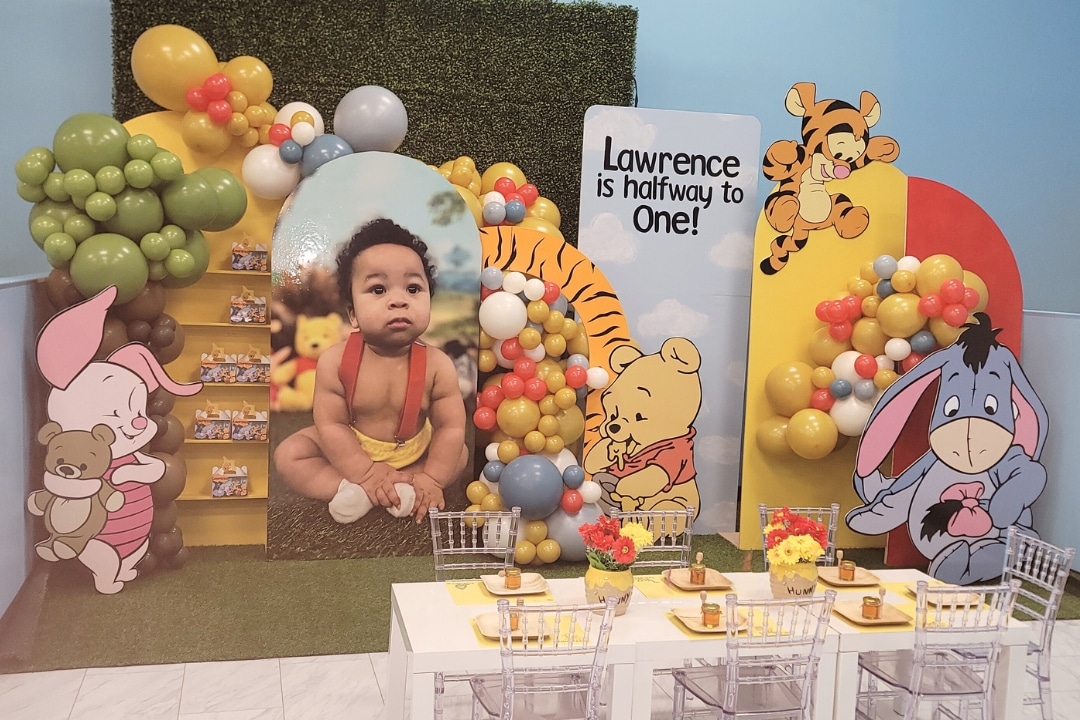 Classic Winnie the Pooh themed half birthday party with custom character cutouts and honey pot props at Kidz Kastle RI