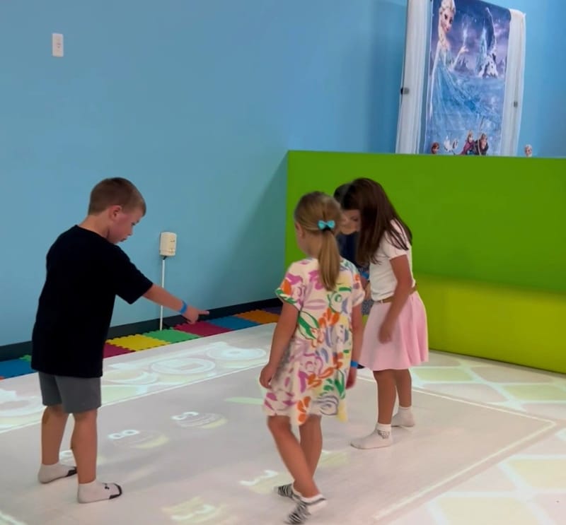 Kids playing on interactive game floor at Kidz Kastle private birthday party venue Warwick Rhode Island