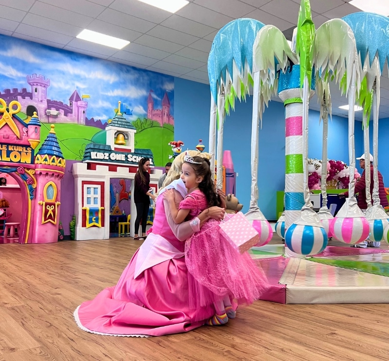 A magical princess character greeting a child during a private birthday party at our kids birthday party venue RI.