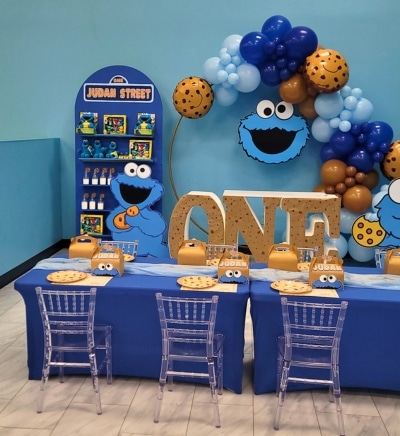 Cookie Monster 1st birthday party theme at Kidz Kastle featuring blue balloon installations, custom "ONE" letters, and Sesame Street themed snacks in Warwick, RI.