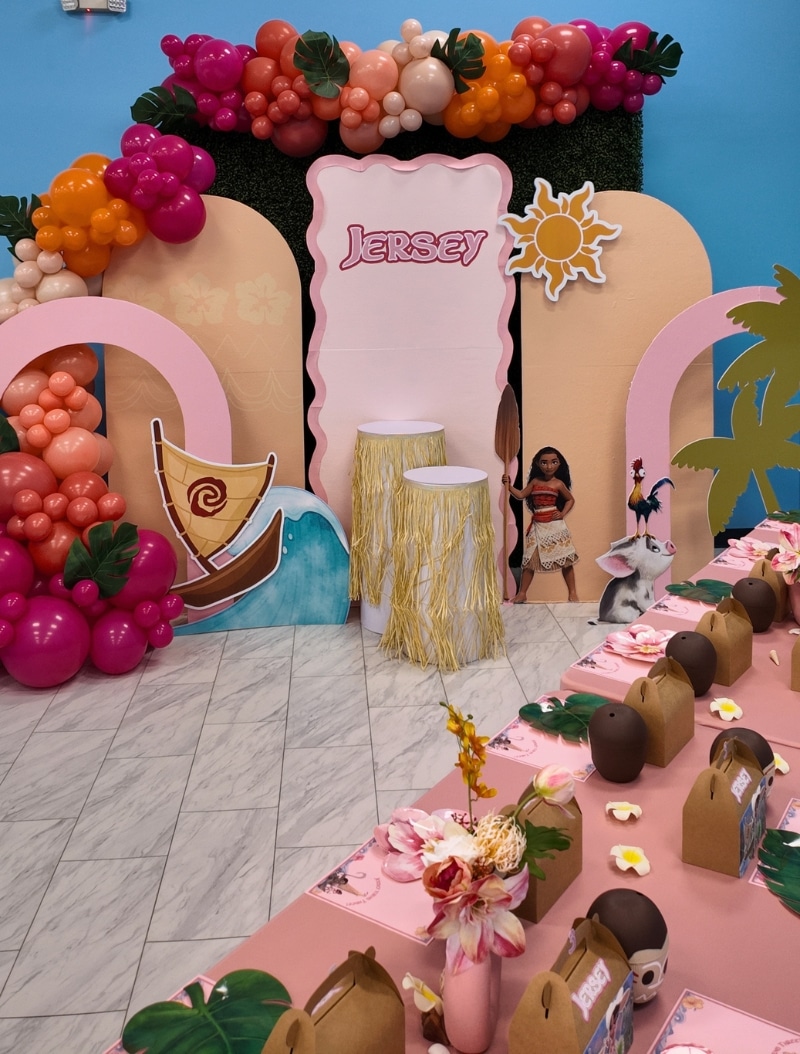 Custom Moana themed birthday party setup at Kidz Kastle in Warwick, RI featuring tropical balloon arches, character cutouts, and themed table settings.
