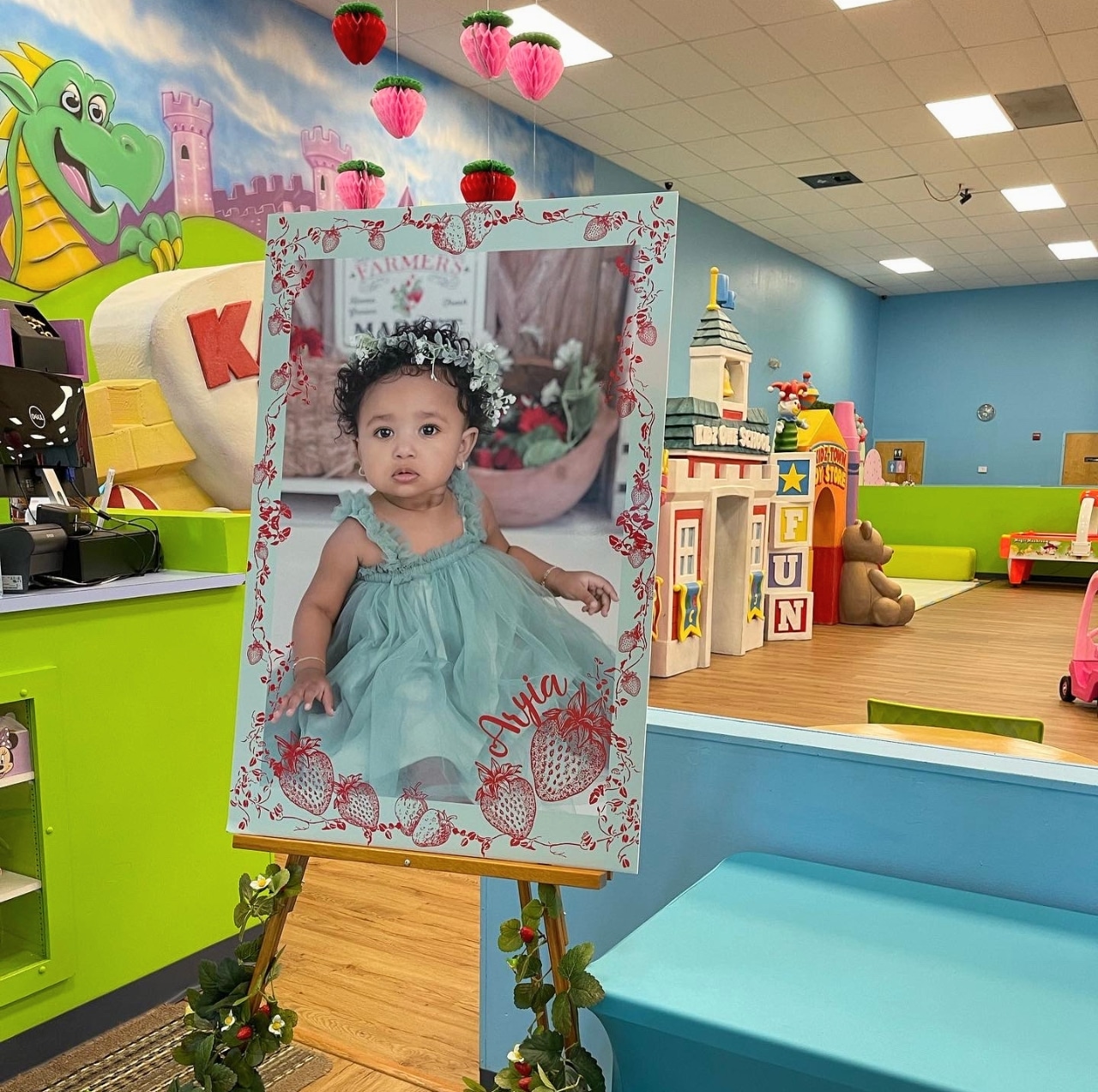 A customized 'Berry First Birthday' welcome sign at the entrance of Kidz Kastle's private indoor Playground party venue in Warwick, Rhode Island.